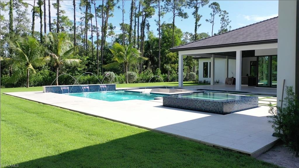 6435 Sable Ridge Lane Naples, FL 34109 - Photo 3 of 8 a view of a house with a yard and sitting area