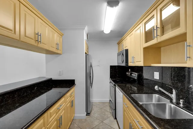 a kitchen with stainless steel appliances a sink a stove and microwave