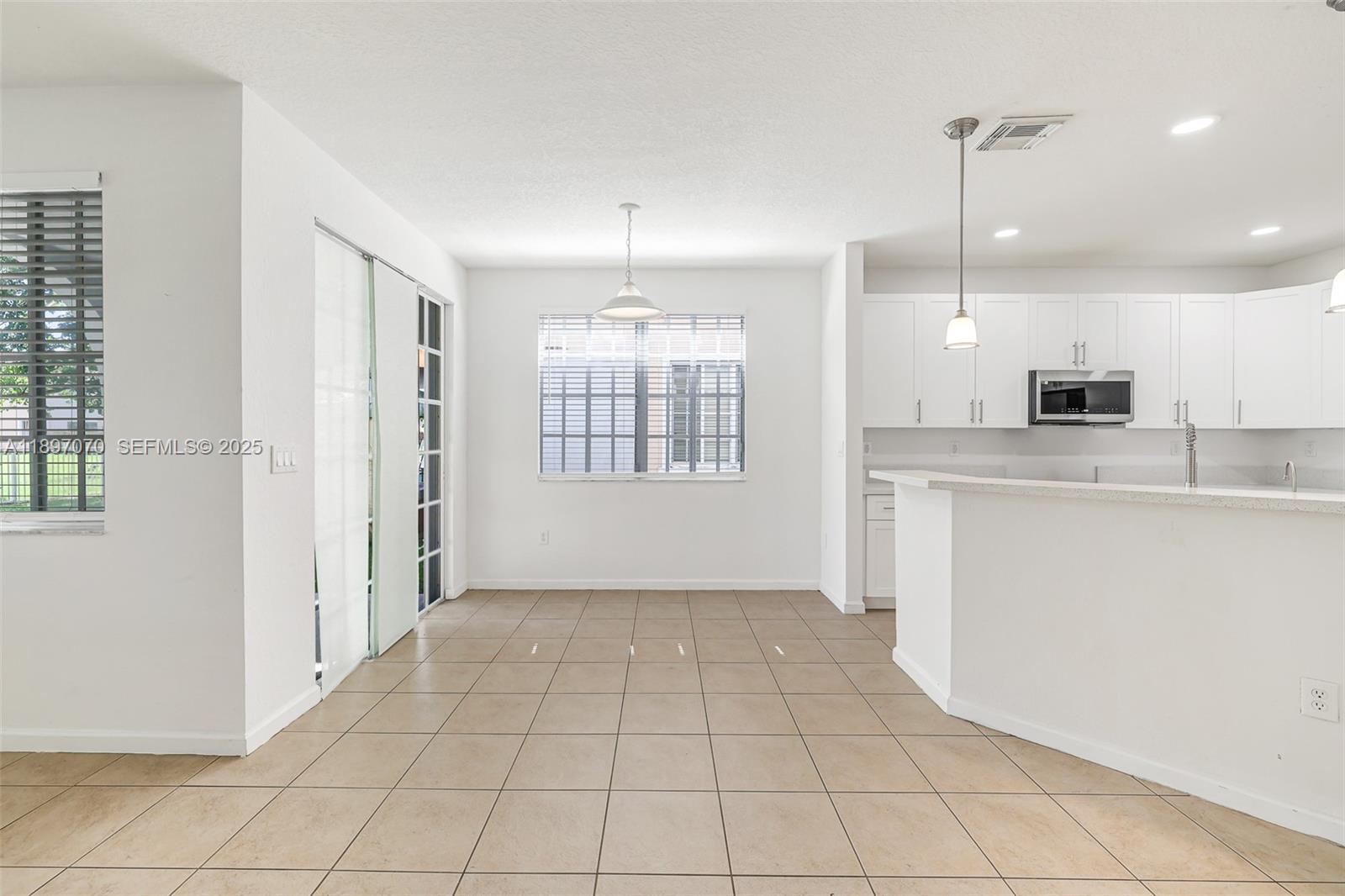 27381 Southwest 139th Place Homestead, FL 33032 - Photo 11 of 70 a view of a kitchen with a sink and dishwasher cabinets