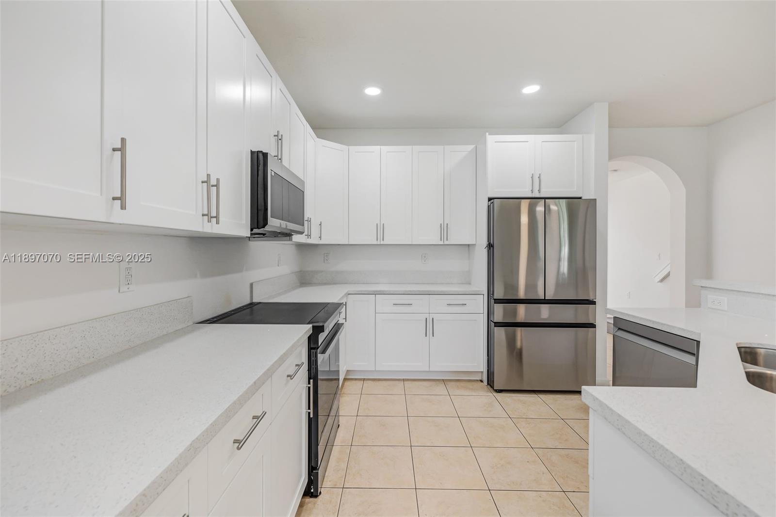 27381 Southwest 139th Place Homestead, FL 33032 - Photo 13 of 70 a kitchen with a refrigerator sink and cabinets