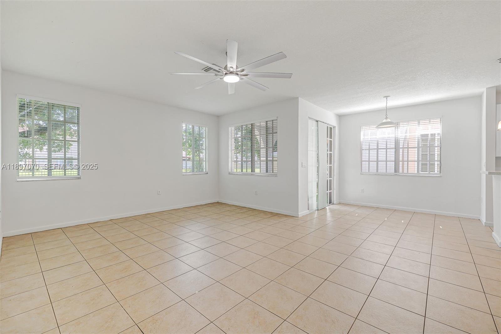 27381 Southwest 139th Place Homestead, FL 33032 - Photo 19 of 70 an empty room with windows and fan
