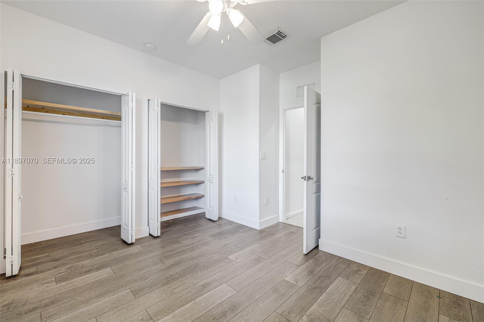 27381 Southwest 139th Place Homestead, FL 33032 - Photo 23 of 70 an empty room with wooden floor closet and windows