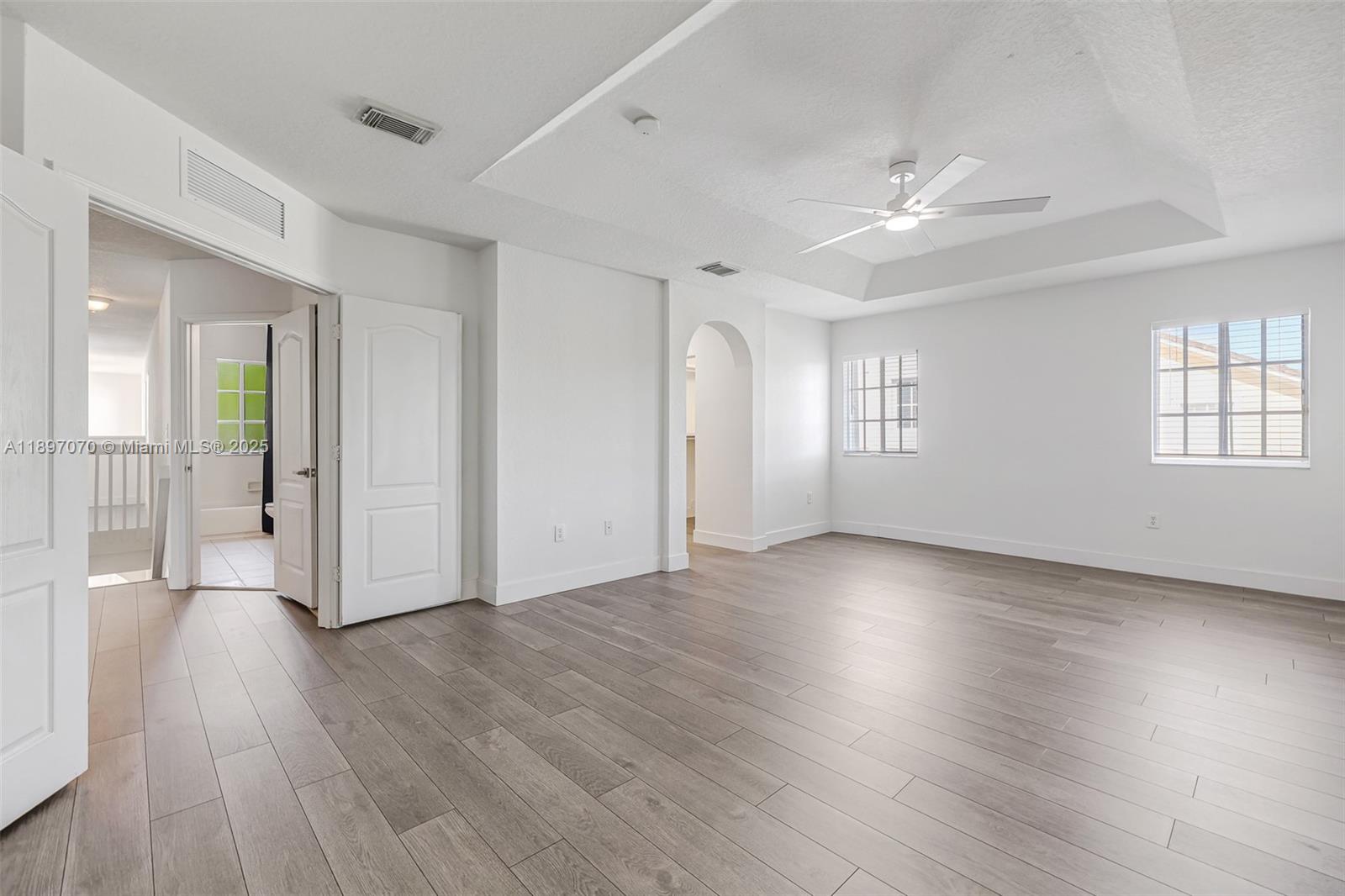 27381 Southwest 139th Place Homestead, FL 33032 - Photo 28 of 70 a view of an empty room with wooden floor and a window