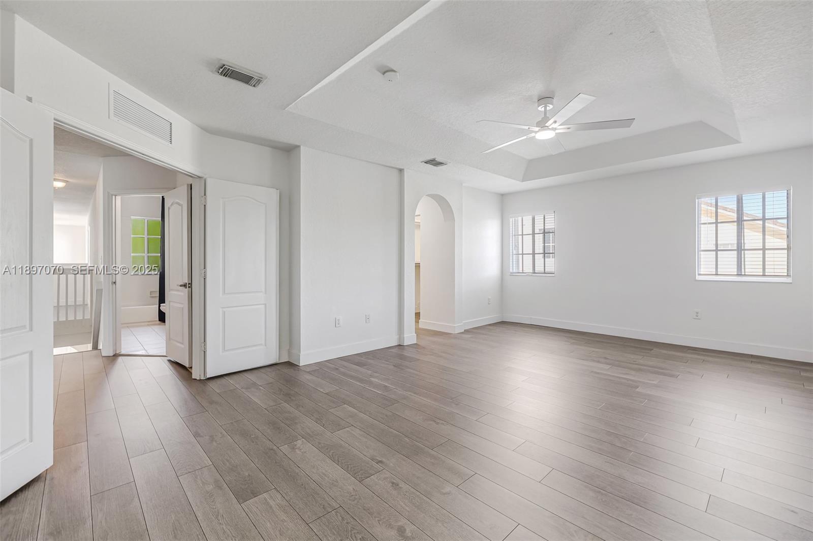 27381 Southwest 139th Place Homestead, FL 33032 - Photo 28 of 70 a view of an empty room with wooden floor and a window