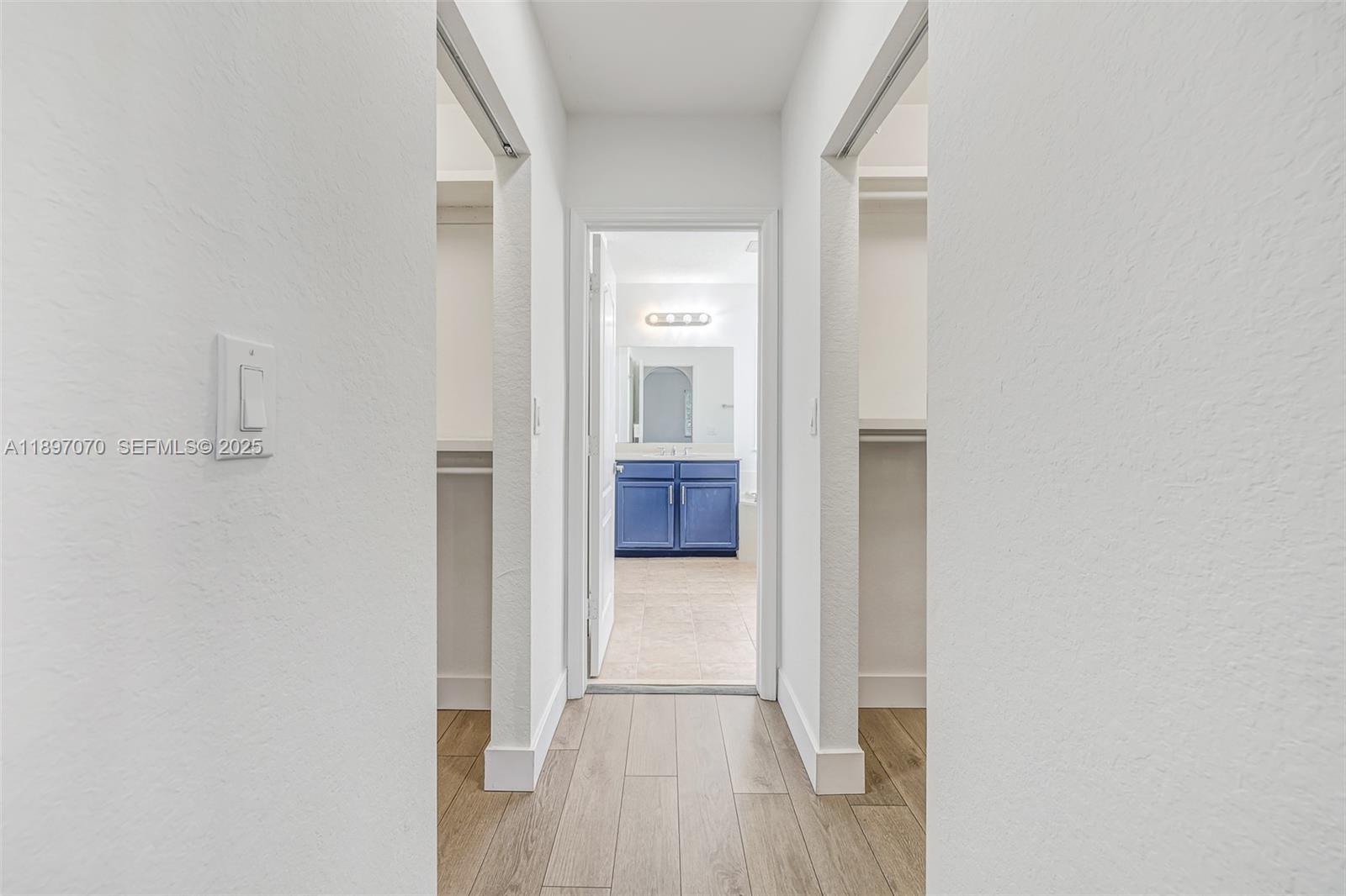 27381 Southwest 139th Place Homestead, FL 33032 - Photo 31 of 70 a view of a hallway with wooden floor and a kitchen