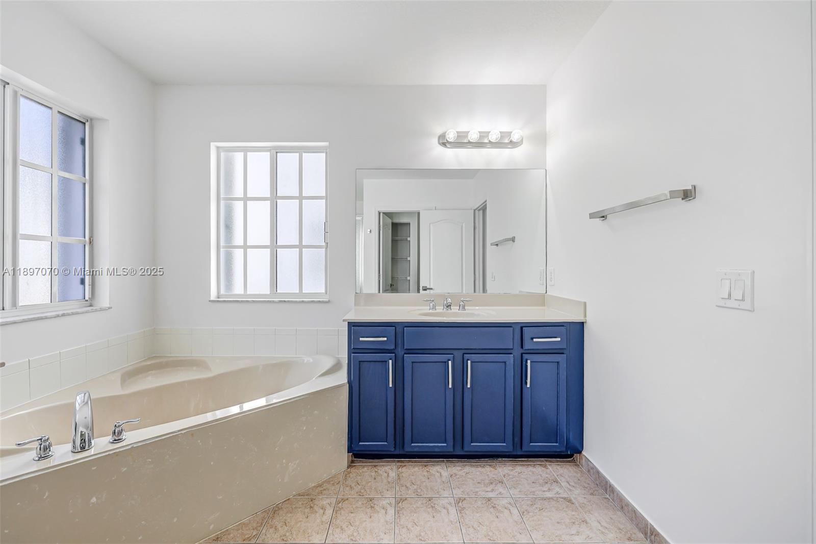 27381 Southwest 139th Place Homestead, FL 33032 - Photo 36 of 70 a bathroom with a tub sink and mirror