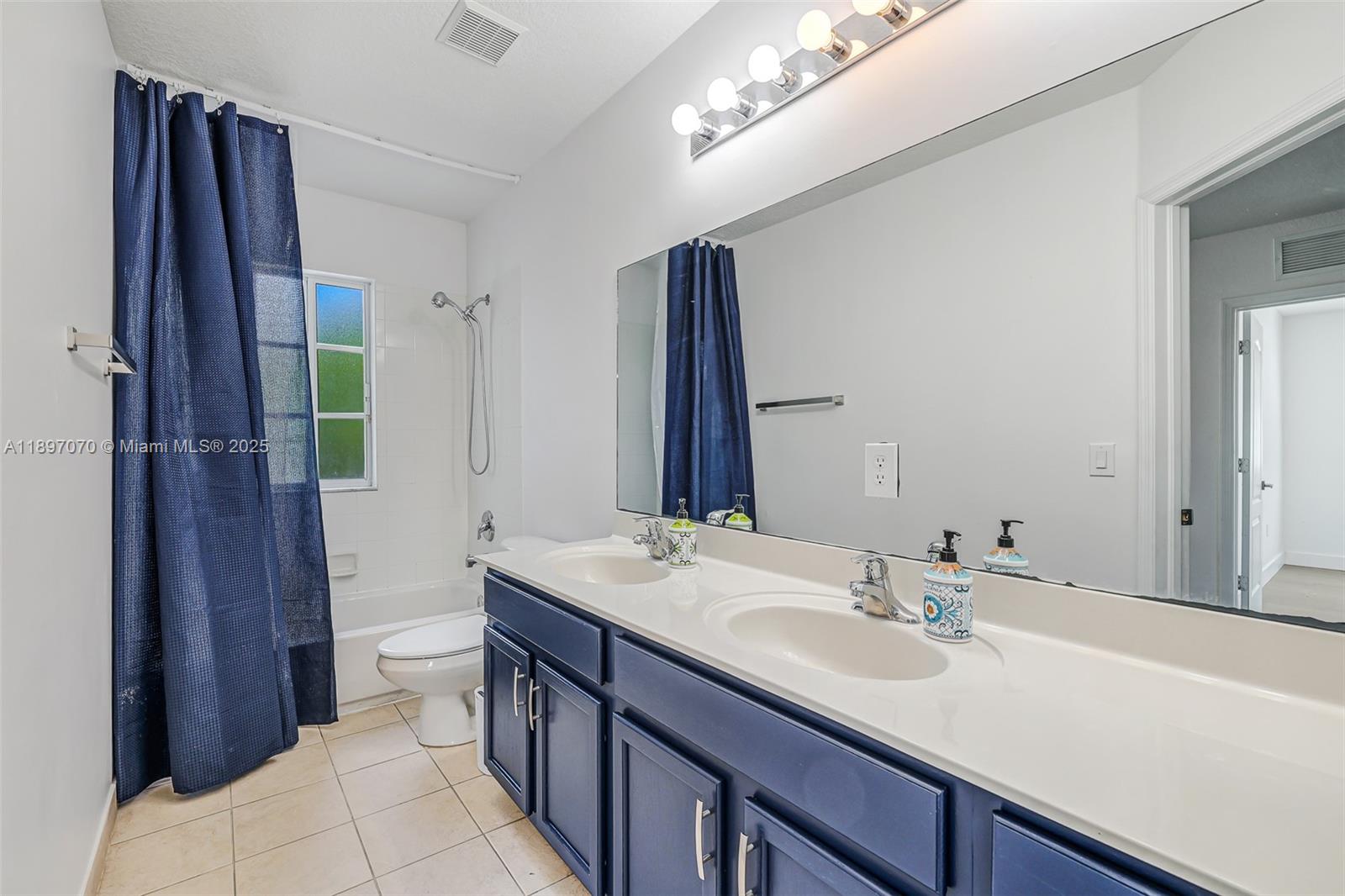 27381 Southwest 139th Place Homestead, FL 33032 - Photo 41 of 70 a bathroom with a double vanity sink and a mirror