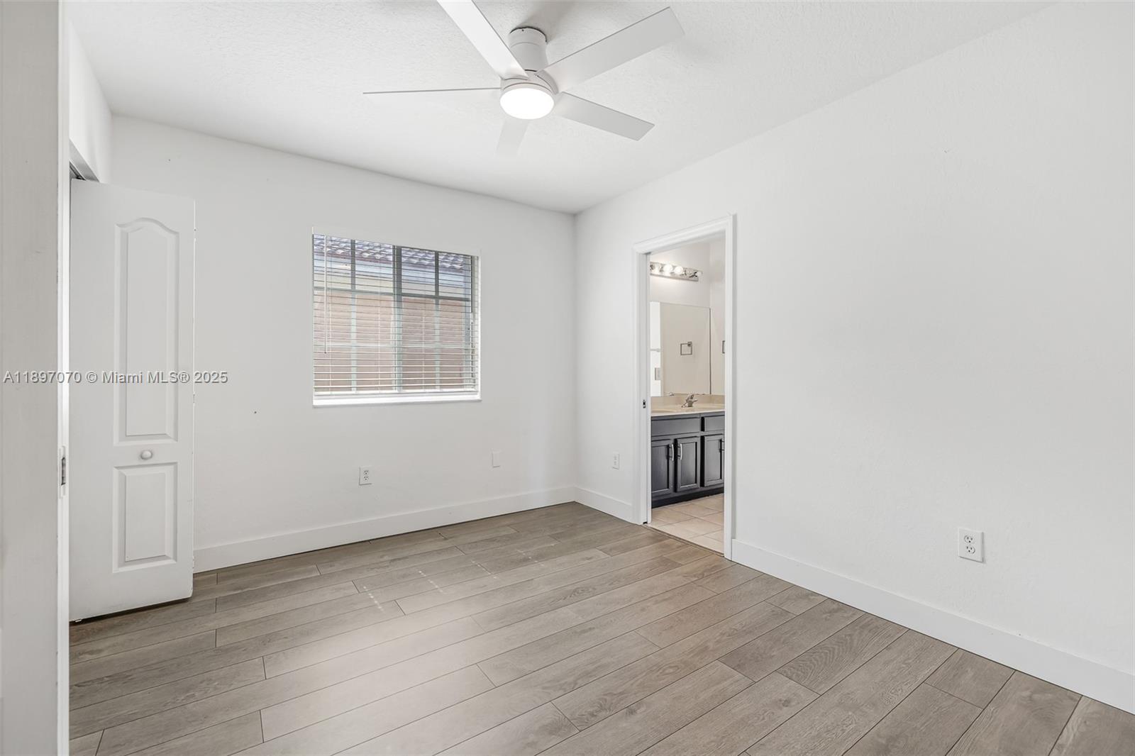 27381 Southwest 139th Place Homestead, FL 33032 - Photo 42 of 70 an empty room with wooden floor cabinet and windows