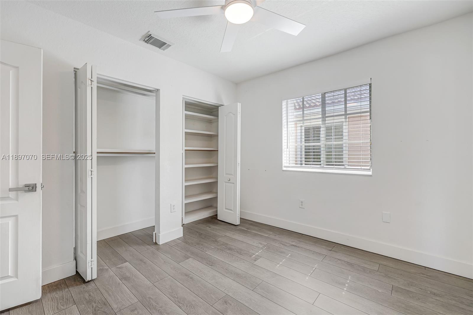 27381 Southwest 139th Place Homestead, FL 33032 - Photo 43 of 70 a view of empty room with wooden floor and window