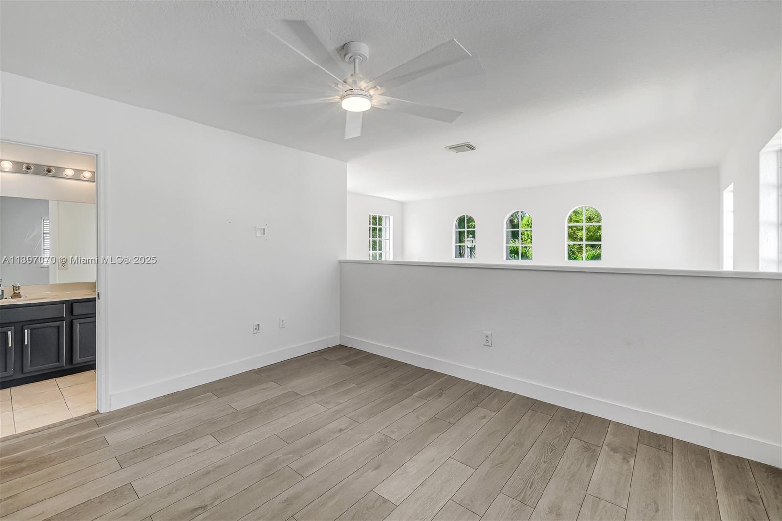 27381 Southwest 139th Place Homestead, FL 33032 - Photo 48 of 70 a view of an empty room with window and wooden floor
