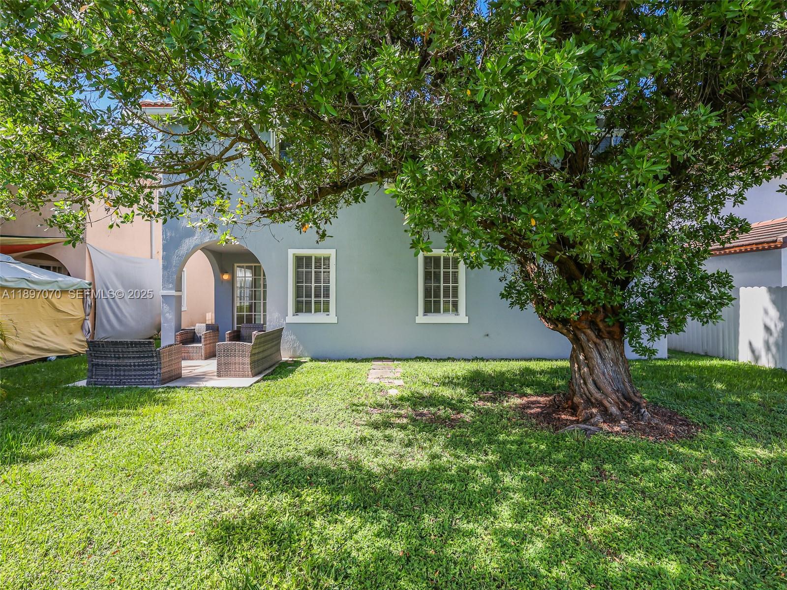 27381 Southwest 139th Place Homestead, FL 33032 - Photo 52 of 70 a backyard of a house with table and chairs