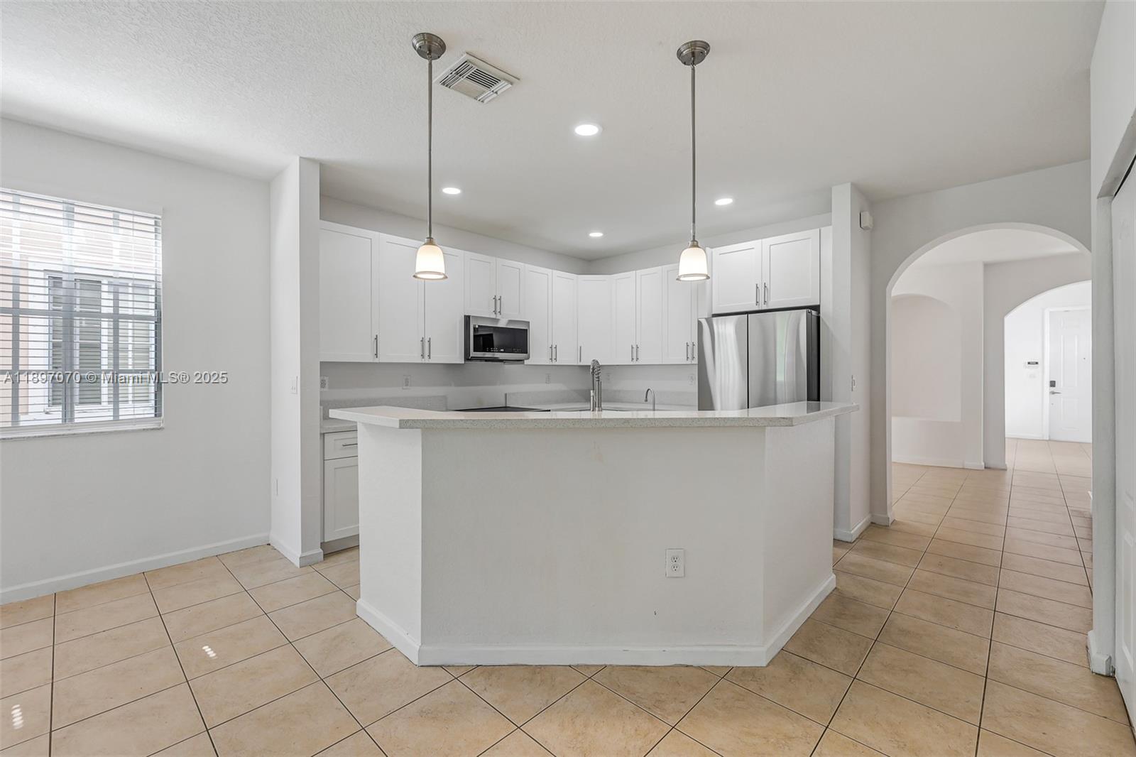 27381 Southwest 139th Place Homestead, FL 33032 - Photo 10 of 70 a view of a kitchen with stainless steel appliances granite countertop a refrigerator a sink and dishwasher