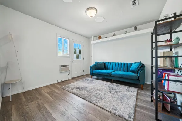 a living room with furniture and a book shelf