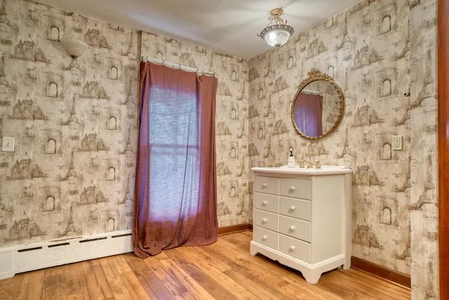 a bathroom with a granite countertop sink mirror vanity and toilet