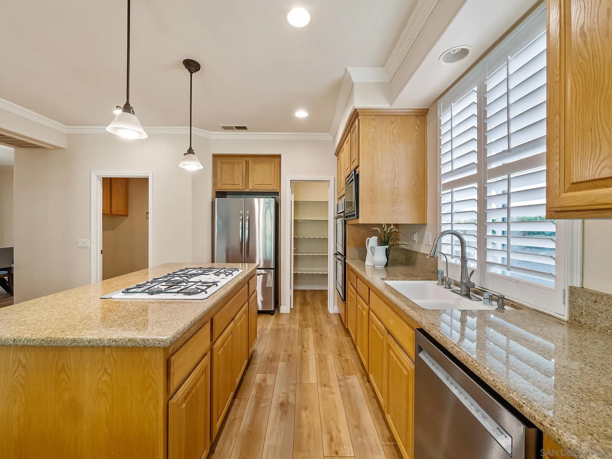 11361 Raedene Way San Diego, CA 92131 - Photo 11 of 57 a kitchen with stainless steel appliances granite countertop a sink a stove and a refrigerator