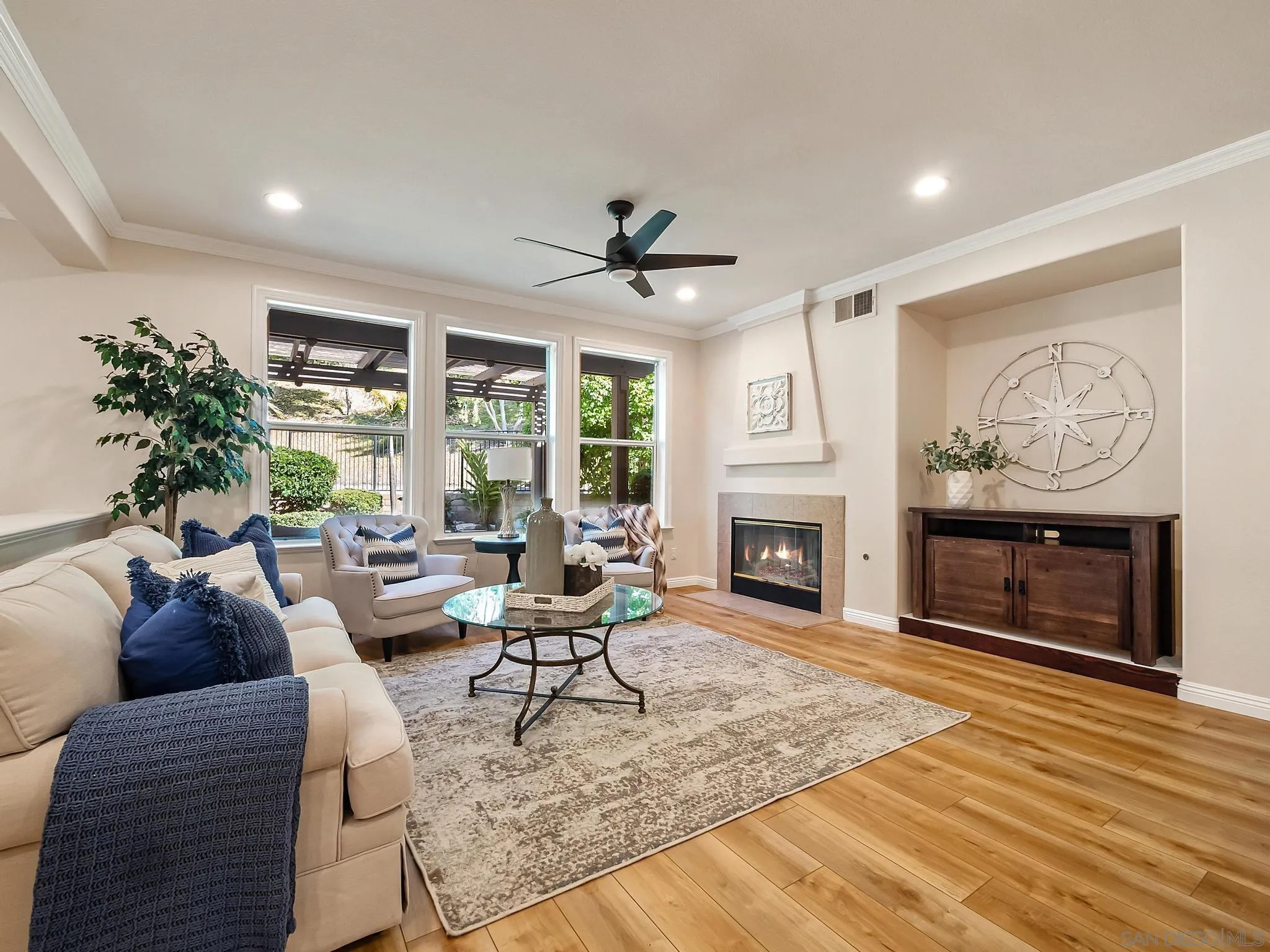 11361 Raedene Way San Diego, CA 92131 - Photo 15 of 57 a living room with furniture a window and a fireplace