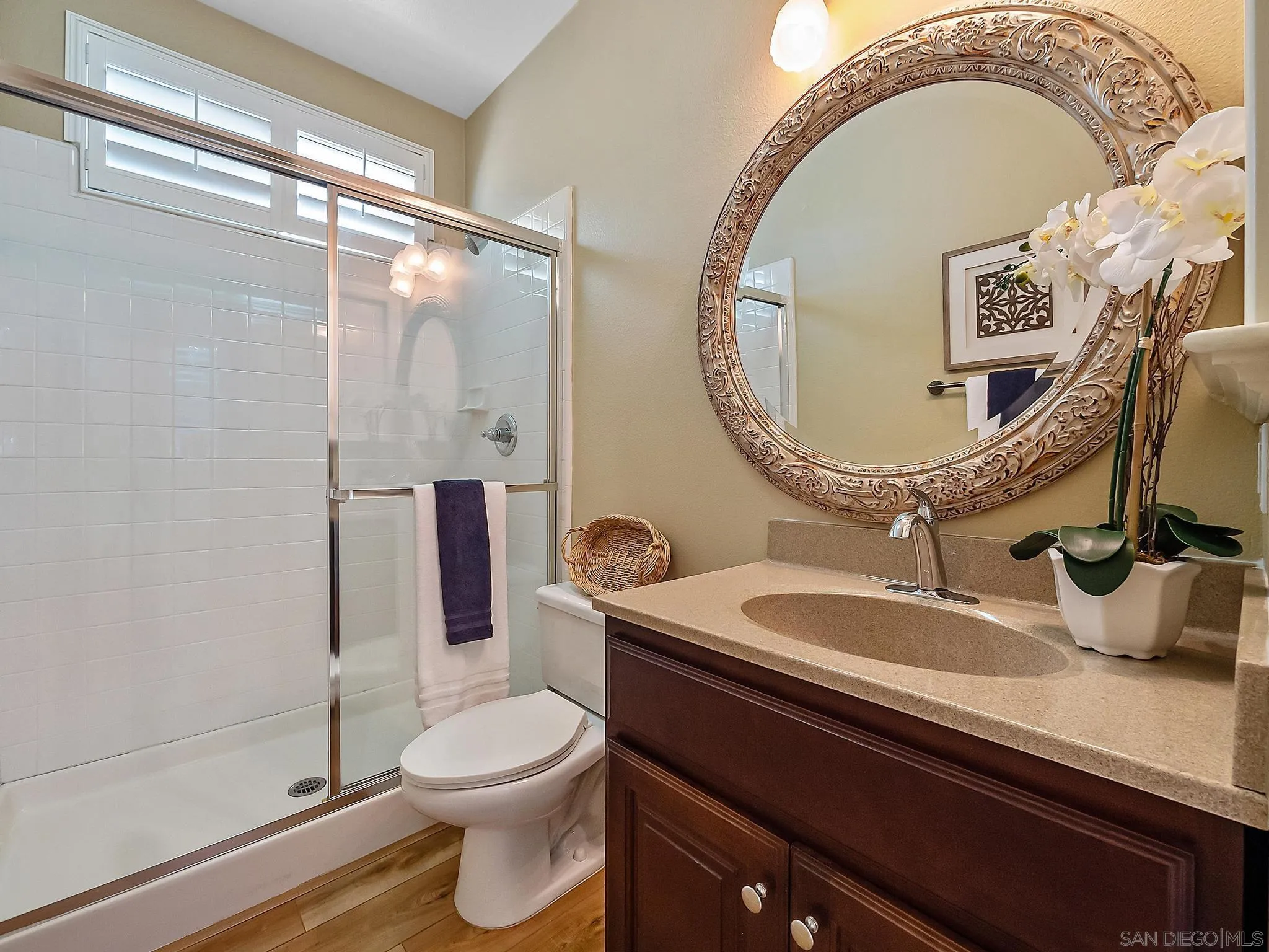 11361 Raedene Way San Diego, CA 92131 - Photo 21 of 57 a bathroom with a toilet a sink and mirror