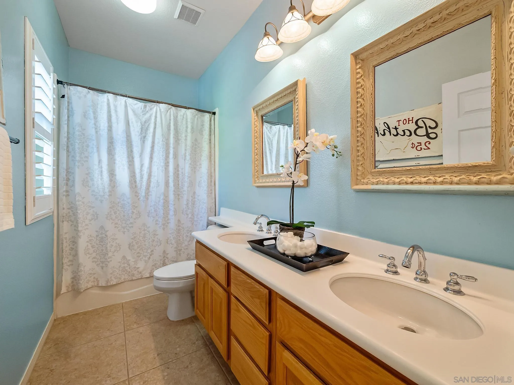 11361 Raedene Way San Diego, CA 92131 - Photo 24 of 57 a bathroom with a granite countertop sink mirror vanity and toilet