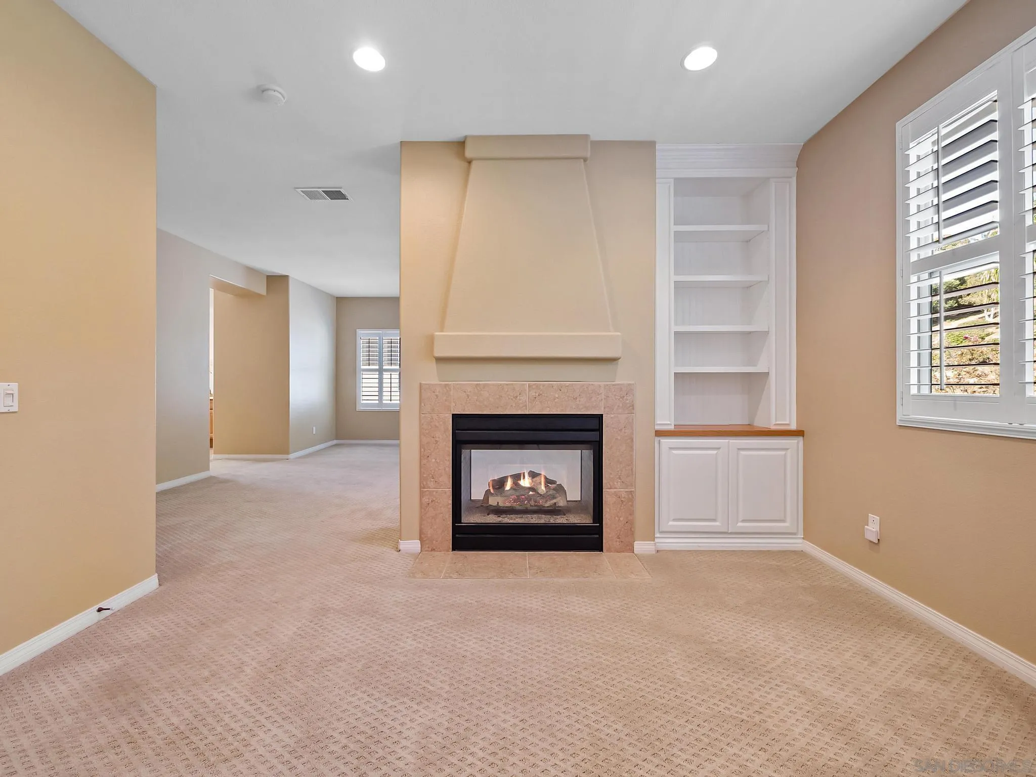 11361 Raedene Way San Diego, CA 92131 - Photo 28 of 57 a view of a livingroom with a fireplace and window