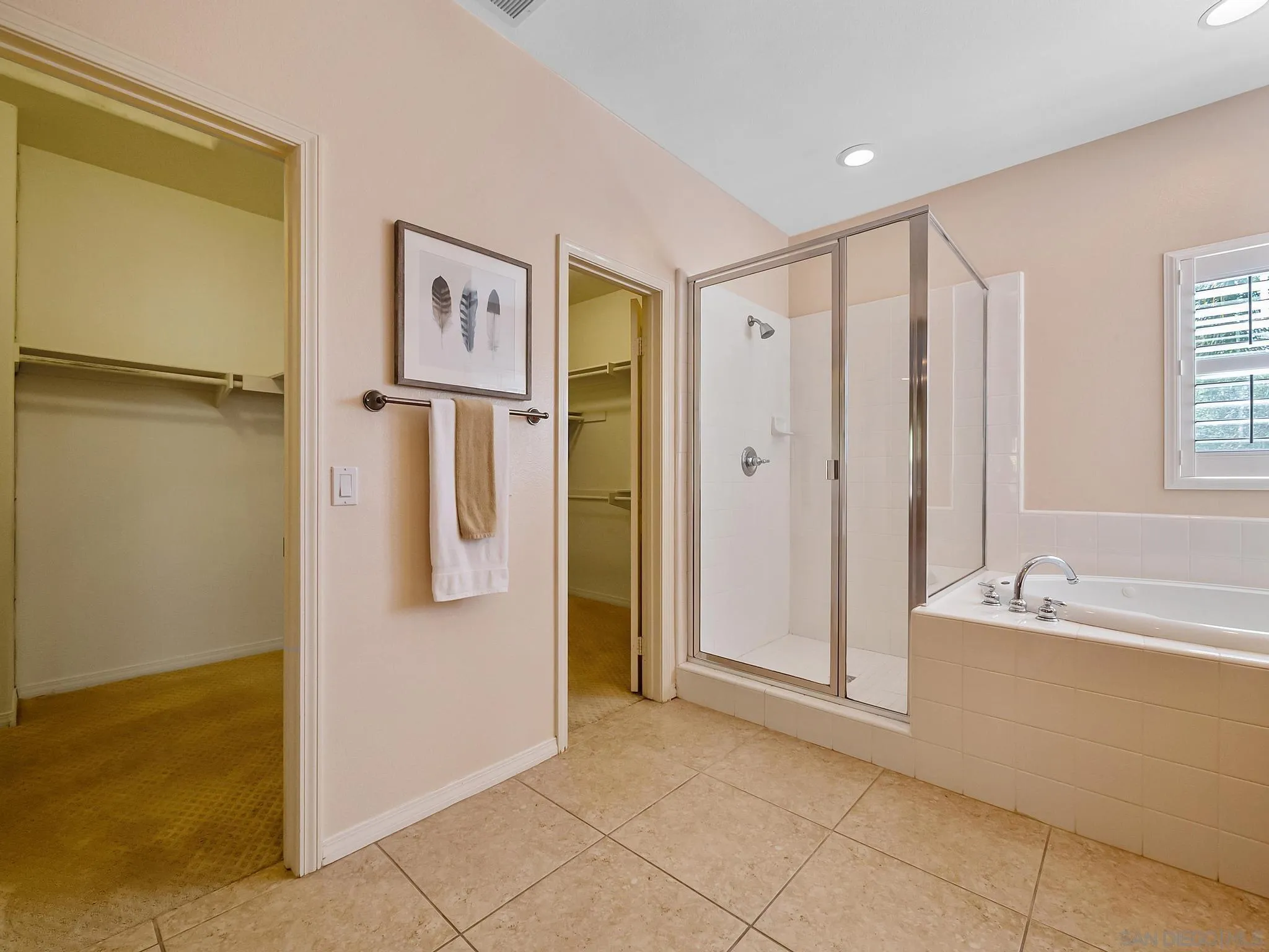 11361 Raedene Way San Diego, CA 92131 - Photo 35 of 57 a spacious bathroom with a double vanity sink a mirror and a bathtub