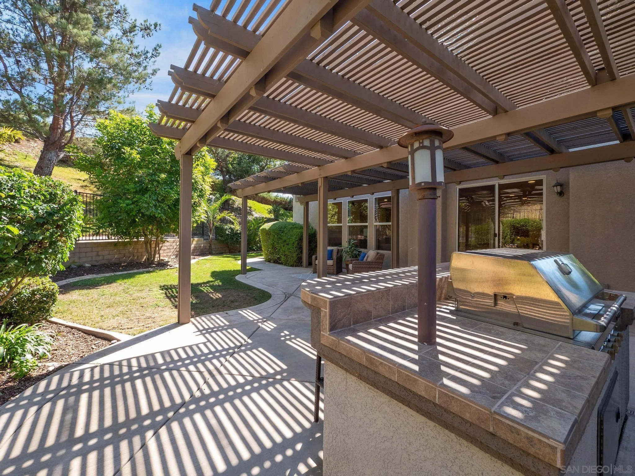 11361 Raedene Way San Diego, CA 92131 - Photo 45 of 57 a view of a patio with table and chairs with wooden floor and fence