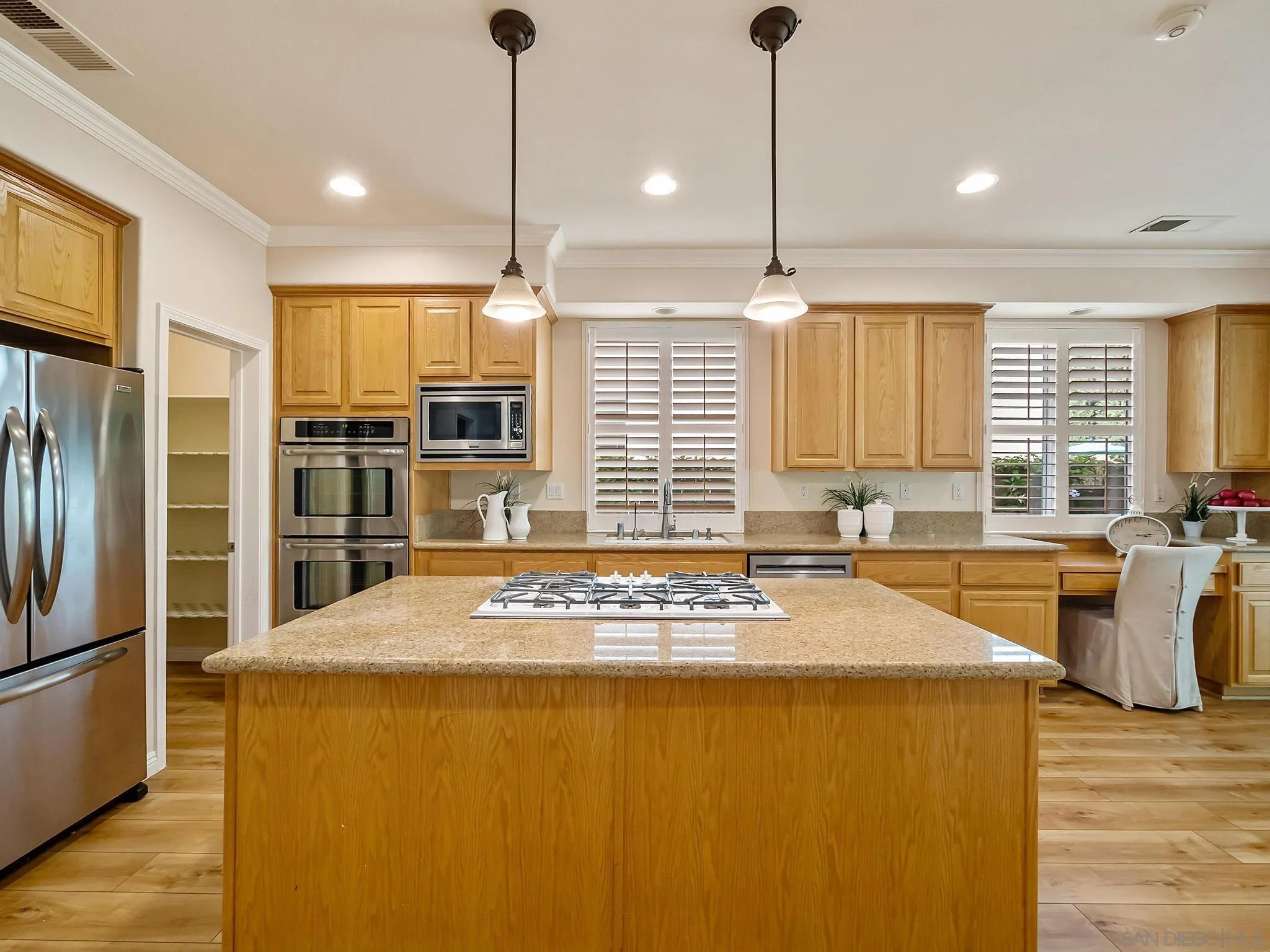11361 Raedene Way San Diego, CA 92131 - Photo 10 of 57 a kitchen with stainless steel appliances granite countertop a sink a stove and refrigerator