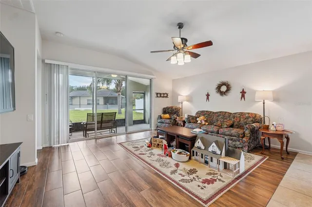 a living room with furniture and a floor to ceiling window