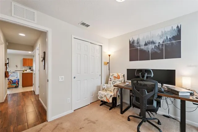 a view of a workspace with furniture and wooden floor