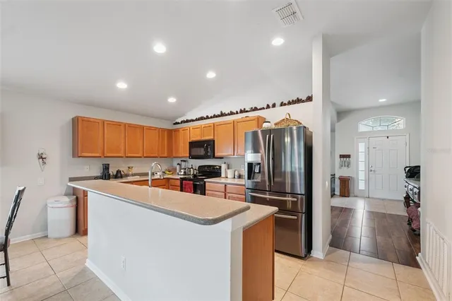 a kitchen with refrigerator and cabinets