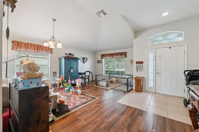 a very nice looking room with many windows and furniture