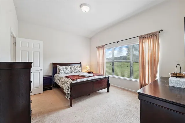 a living room with a bed furniture and a large window