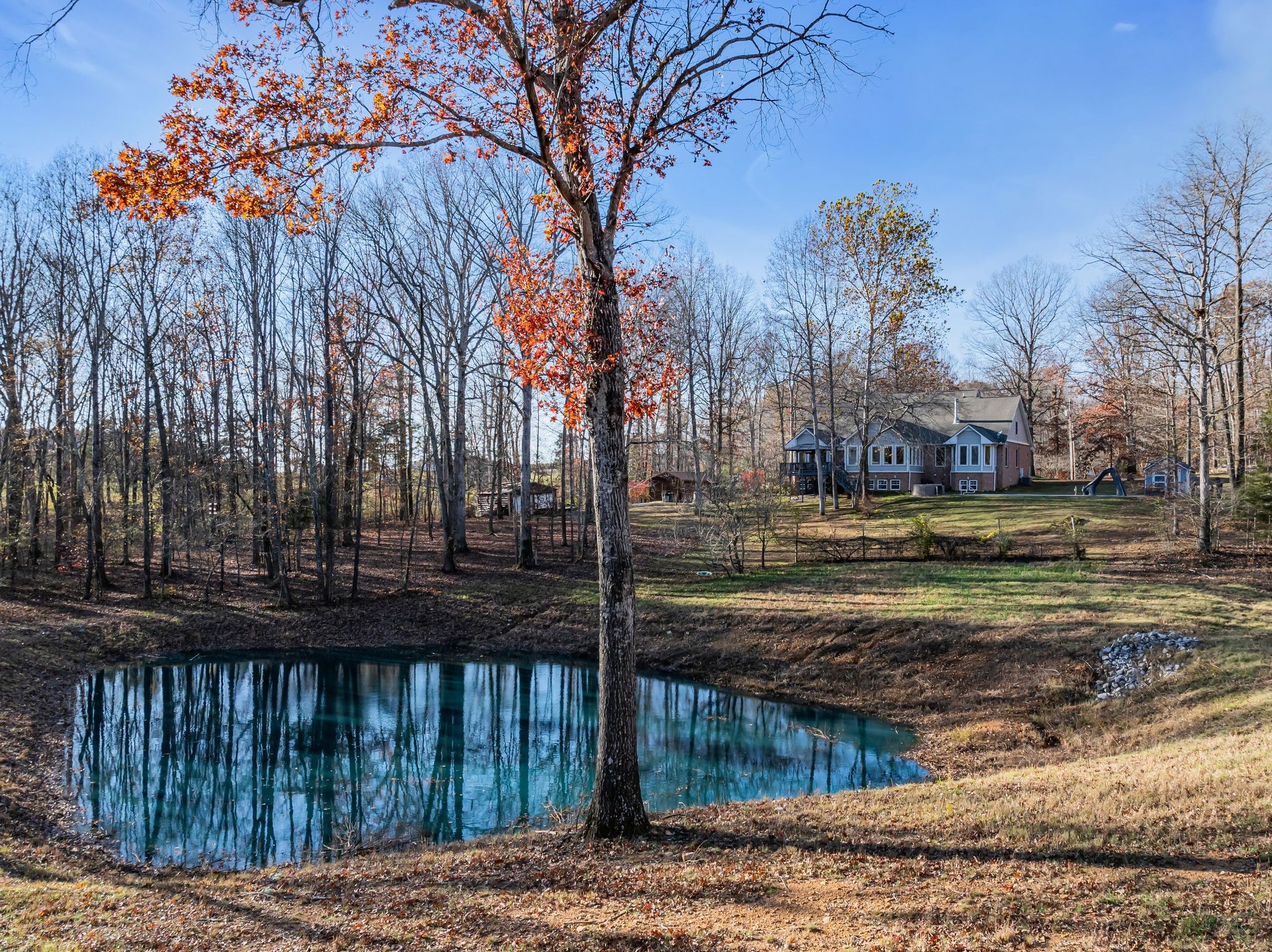 1265 Johnny Hall Road Burns, TN 37029 - Photo 72 of 89 A fully stocked pond with clear blue water—ideal for fishing and unwinding in nature.