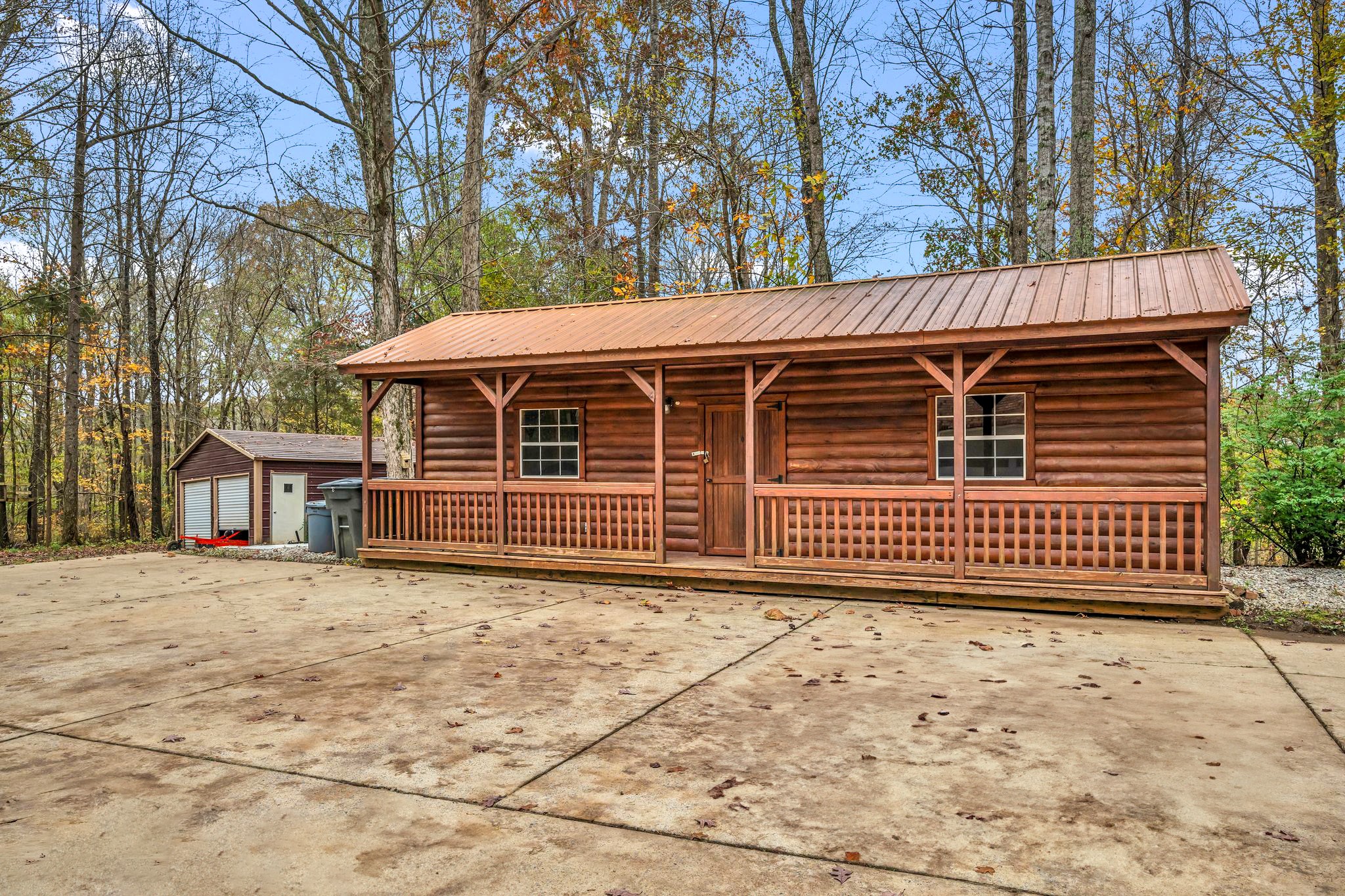 1265 Johnny Hall Road Burns, TN 37029 - Photo 77 of 89 Extra storage and workspace with the detached shop and shed—perfect for 4-wheelers, tools, and more!