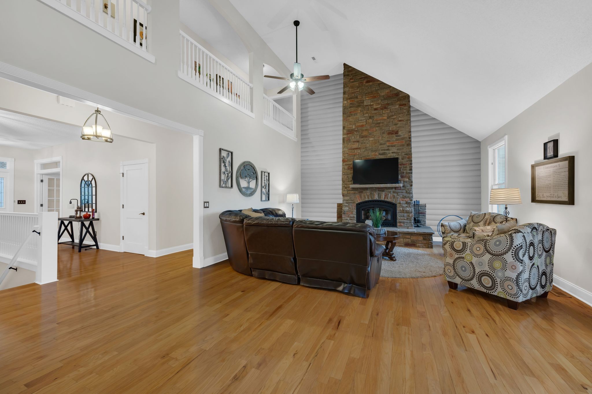 1265 Johnny Hall Road Burns, TN 37029 - Photo 10 of 89 The home opens to an expansive living area with vaulted ceilings and a stunning stone wood-burning fireplace.