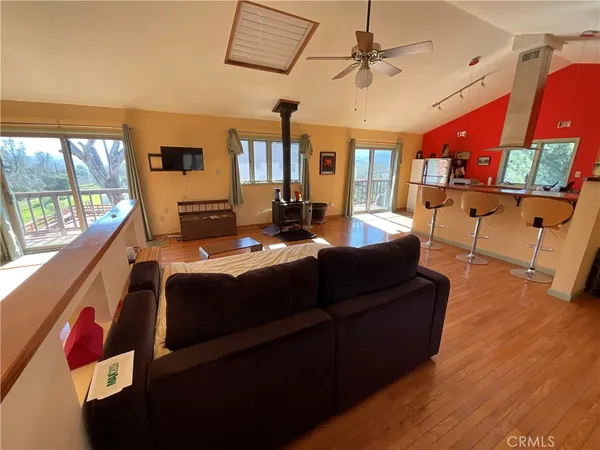 a living room with furniture and a floor to ceiling window