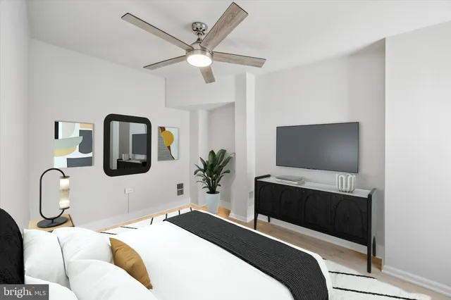 a bedroom with a bed and a flat screen tv