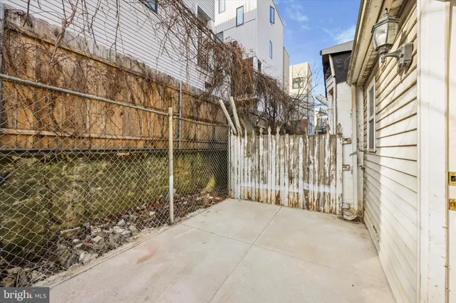 a view of a house with a wooden fence