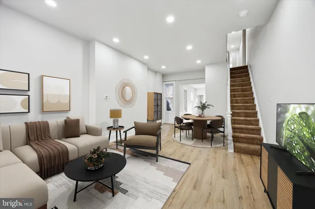 a living room with furniture and wooden floor