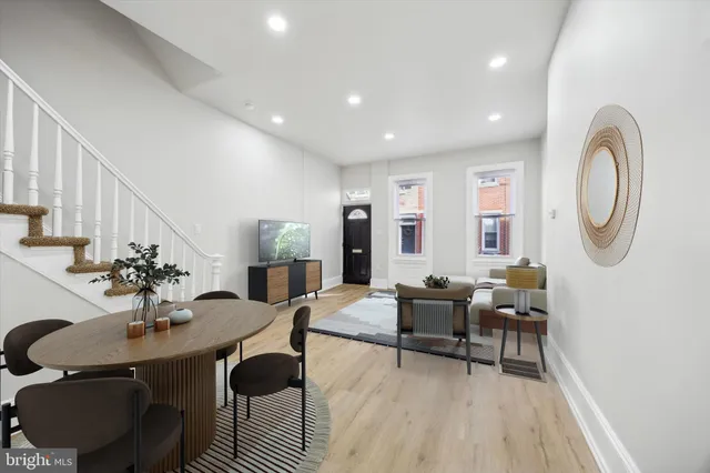 a living room with furniture a wooden floor and a chandelier