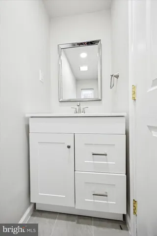 a bathroom with a sink a vanity and a mirror