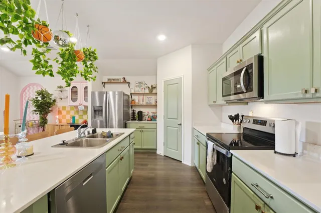 a kitchen with stainless steel appliances kitchen island granite countertop a sink and stove
