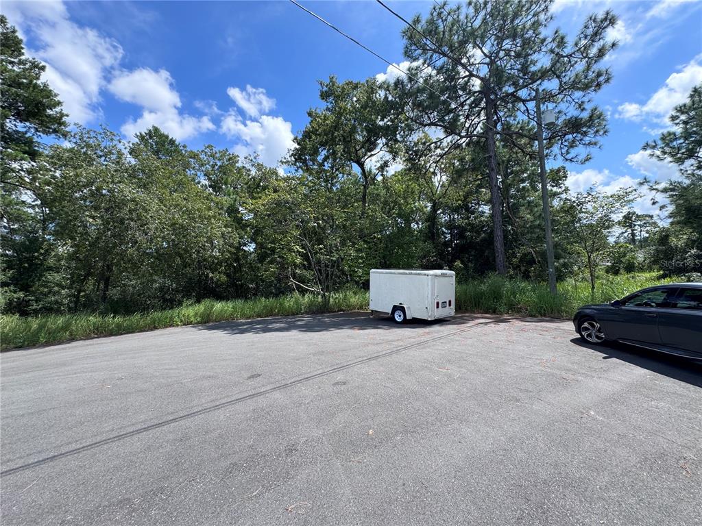 Oak Pass Loop Ocala, FL 34472 - Photo 2 of 4 a backyard of a house with lots of green space and garden
