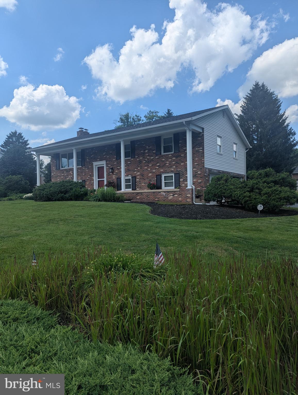 120 Margate Road York, PA 17408 - Photo 2 of 28 a front view of a house with a garden and trees