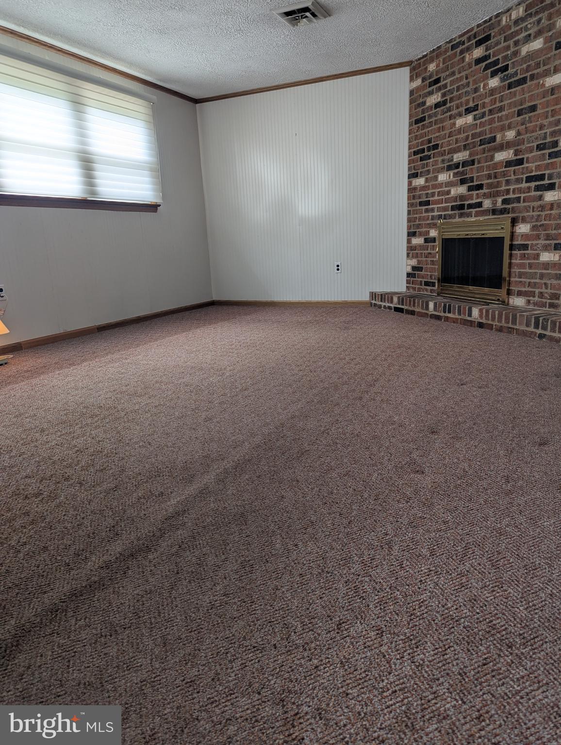 120 Margate Road York, PA 17408 - Photo 25 of 28 an empty room with a fireplace and windows
