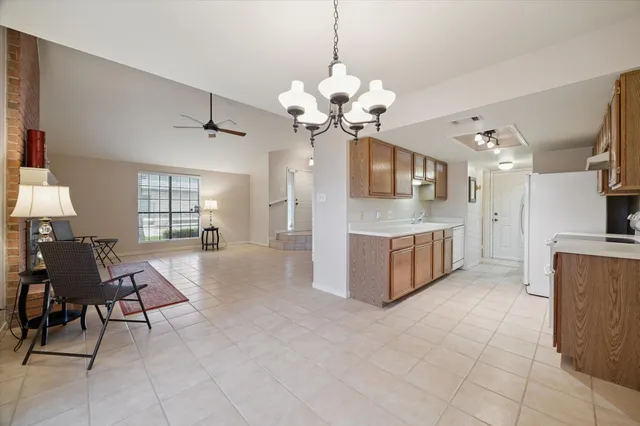 a living room with kitchen island furniture and a chandelier