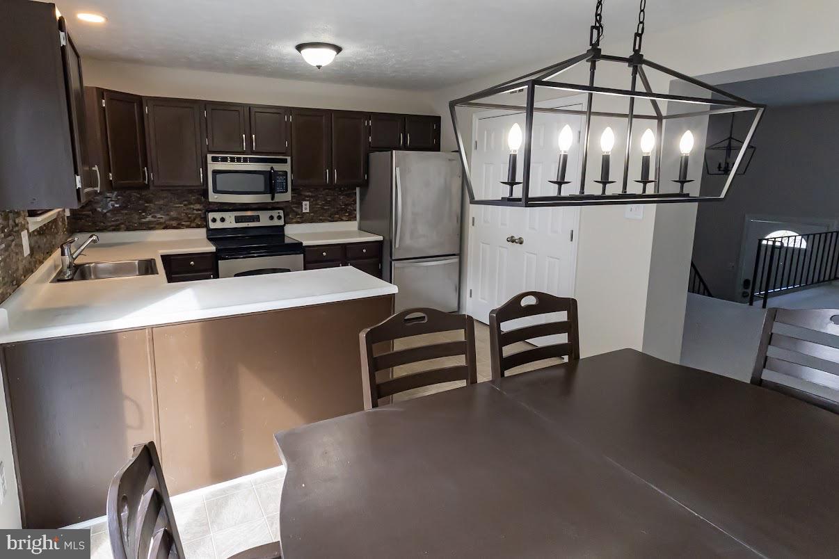 511 Kosoak Road Baltimore, MD 21220 - Photo 15 of 63 a kitchen with stainless steel appliances a microwave a stove and refrigerator