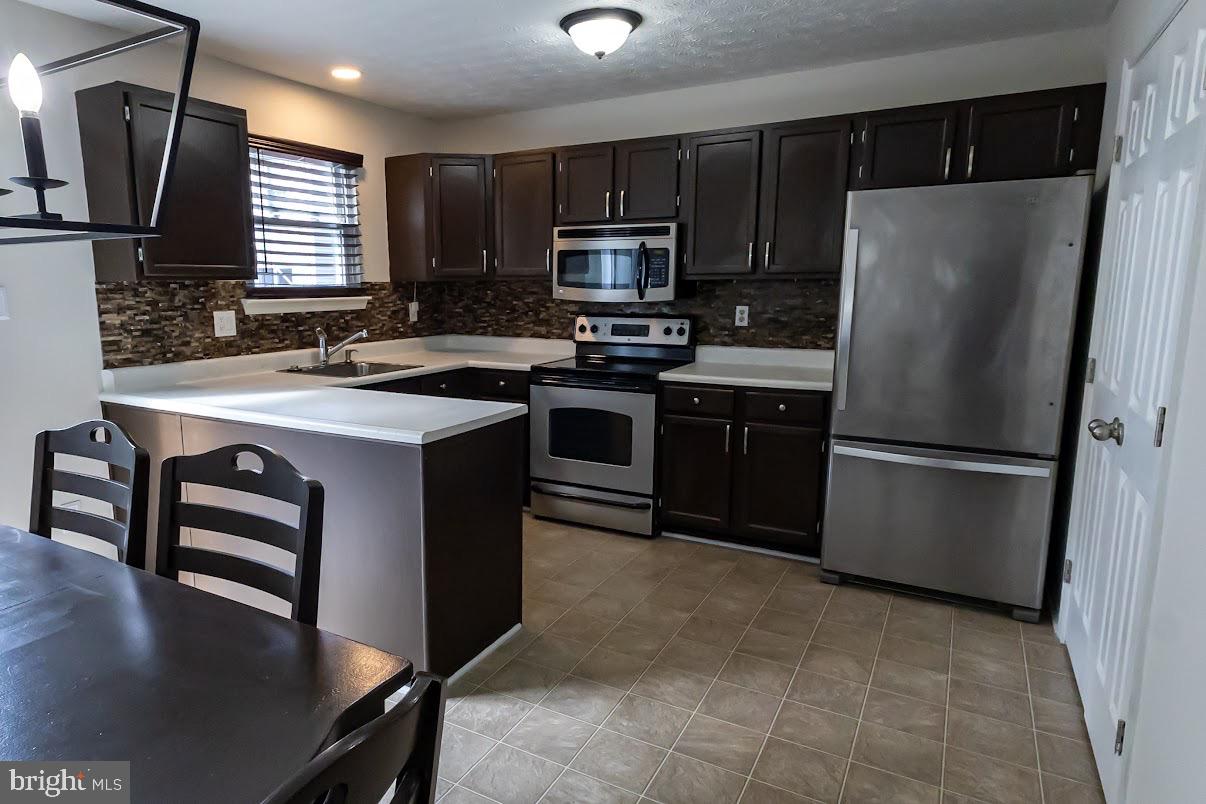 511 Kosoak Road Baltimore, MD 21220 - Photo 16 of 63 a kitchen with stainless steel appliances granite countertop a refrigerator stove a sink and dishwasher
