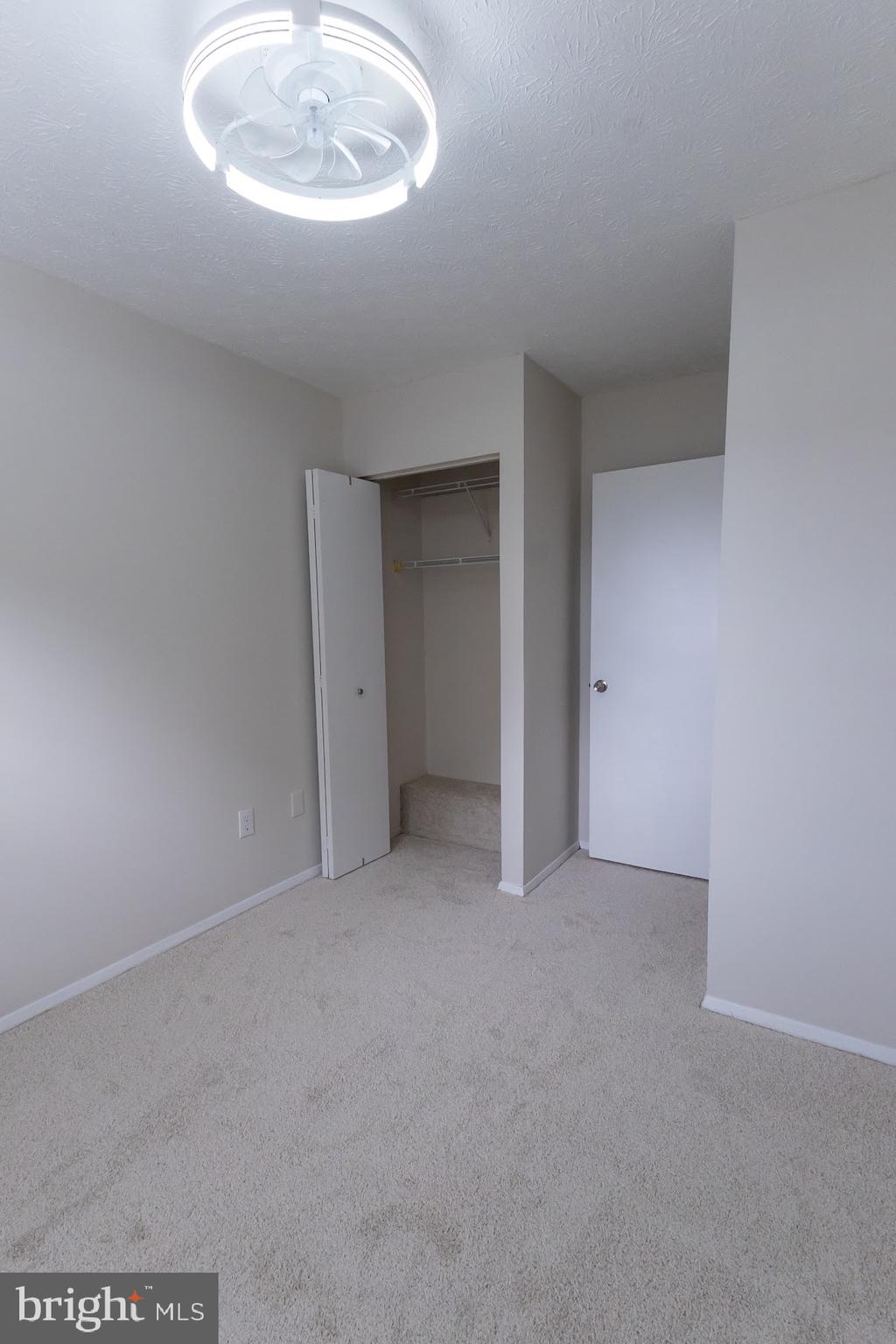 511 Kosoak Road Baltimore, MD 21220 - Photo 26 of 63 an empty room with a fireplace and chandelier