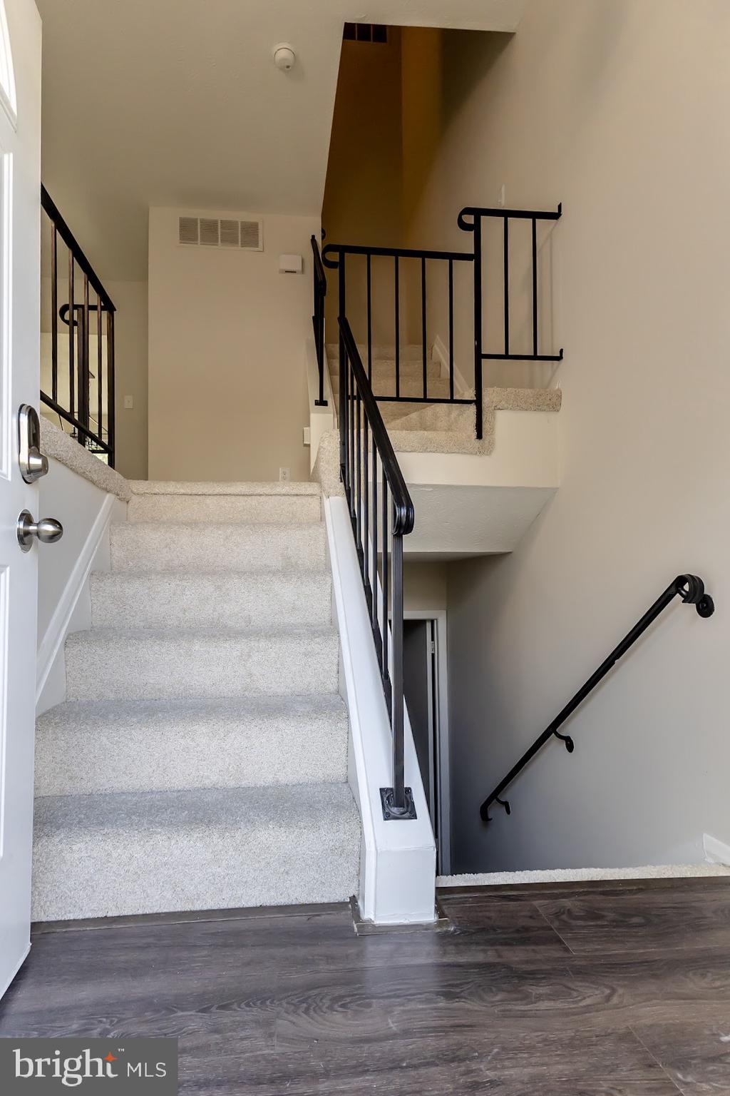511 Kosoak Road Baltimore, MD 21220 - Photo 3 of 63 a view of staircase with white walls and railing