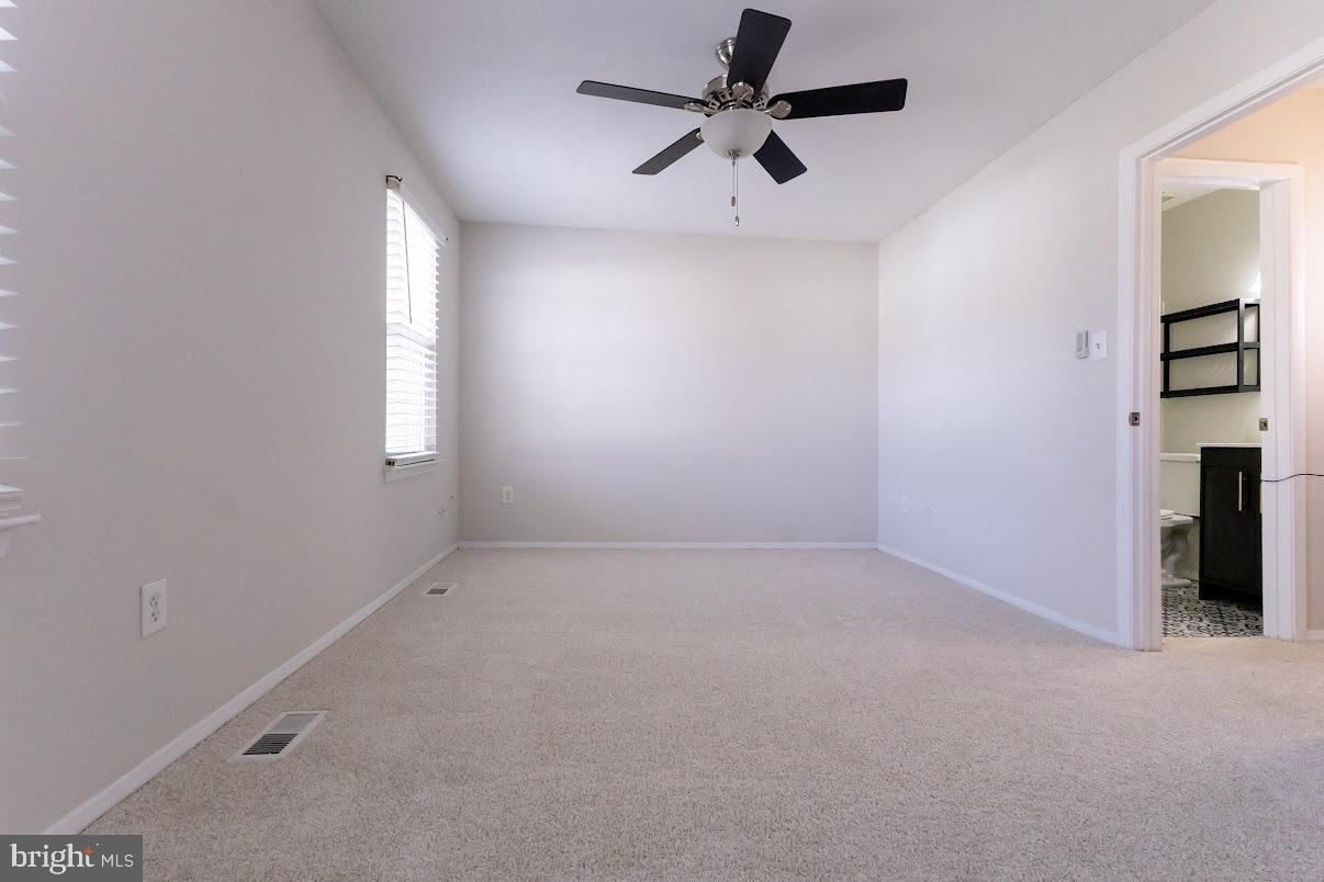 511 Kosoak Road Baltimore, MD 21220 - Photo 38 of 63 en empty room with windows and ceiling fan